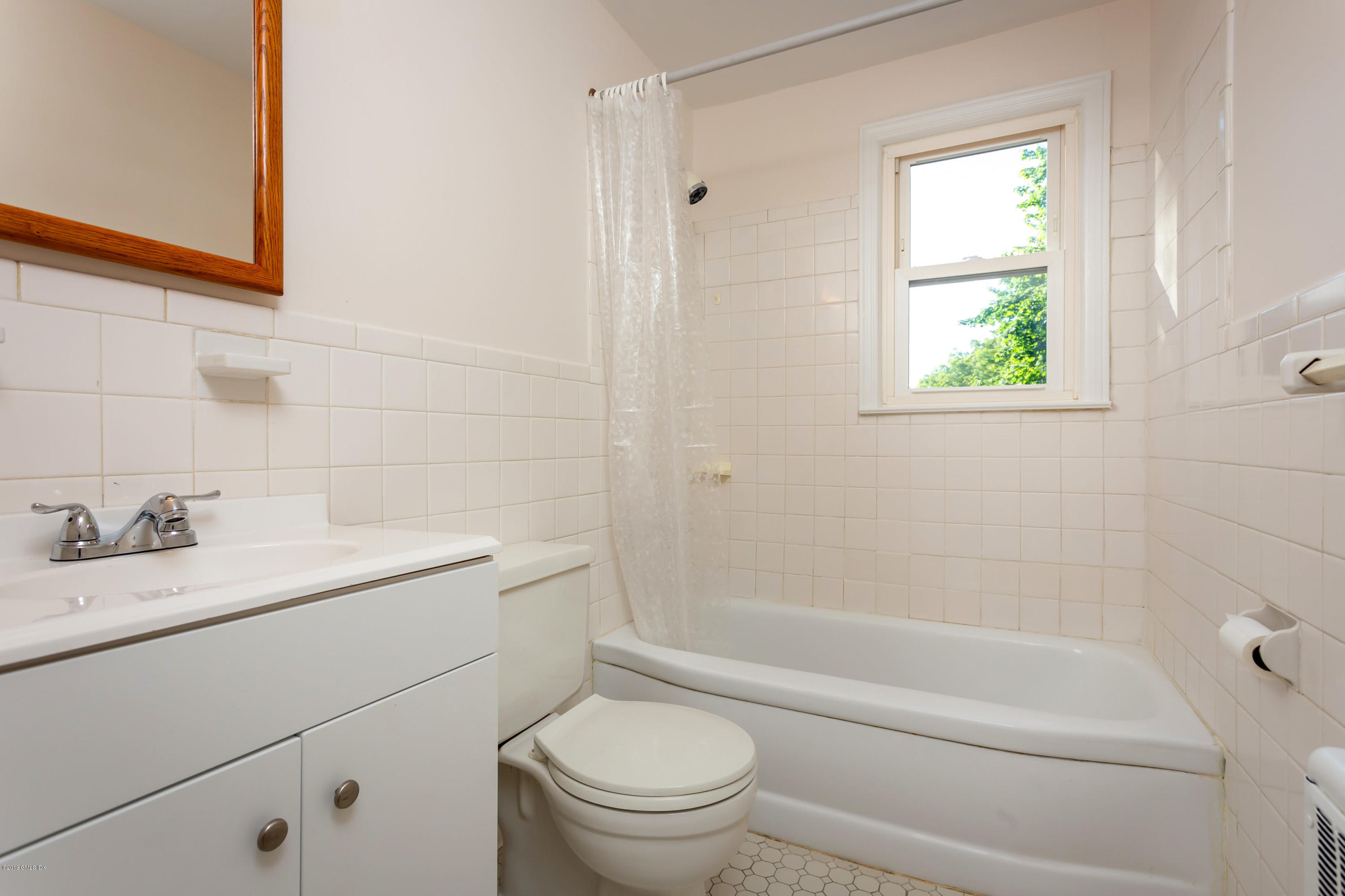 20 Silver Beech Road Riverside, CT 06878 - Photo 19 of 33 a bathroom with a granite countertop toilet a sink and a bathtub