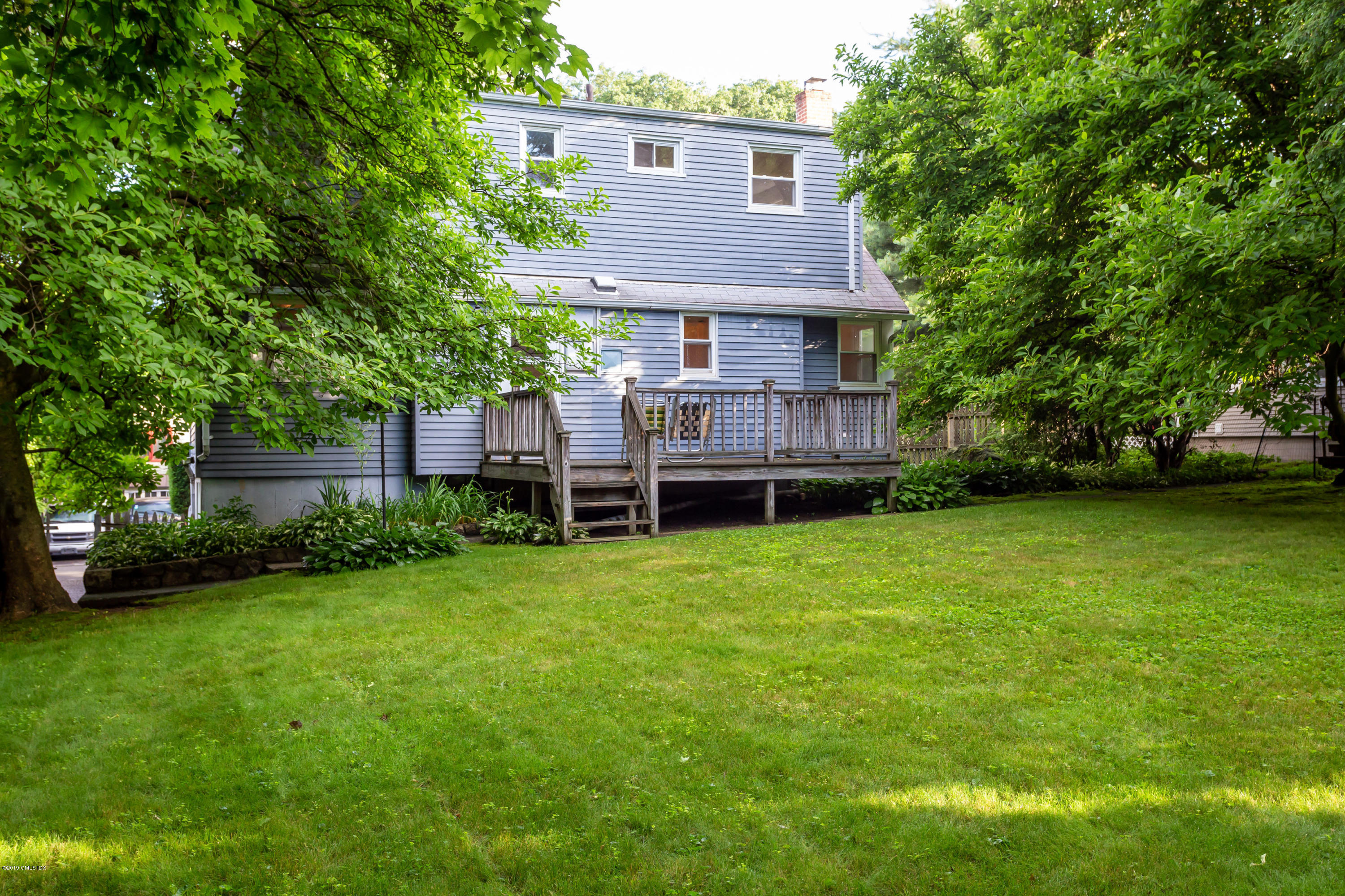 20 Silver Beech Road Riverside, CT 06878 - Photo 26 of 33 a view of a house next to a big yard and large trees