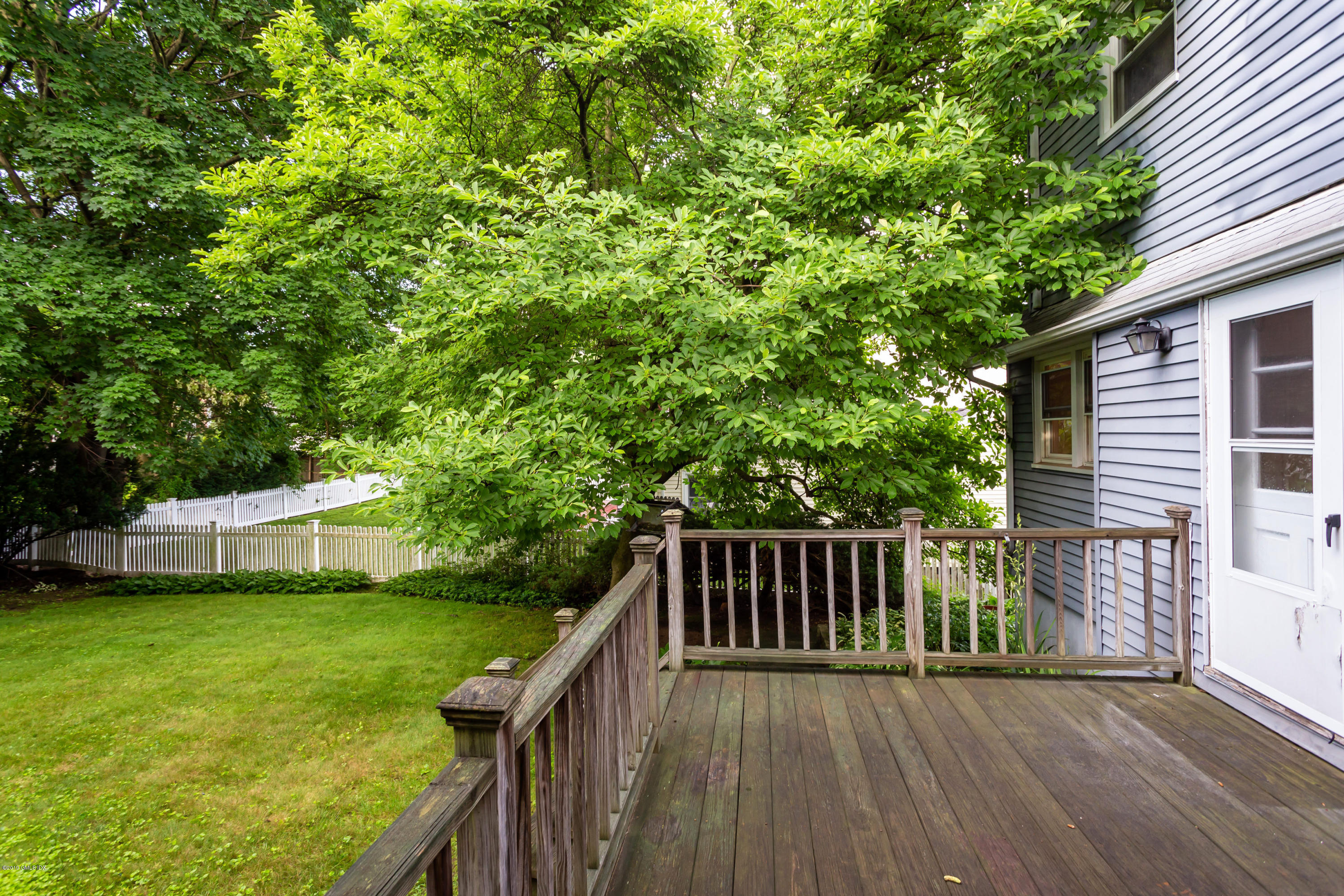 20 Silver Beech Road Riverside, CT 06878 - Photo 29 of 33 a view of a deck with a large window and wooden fence