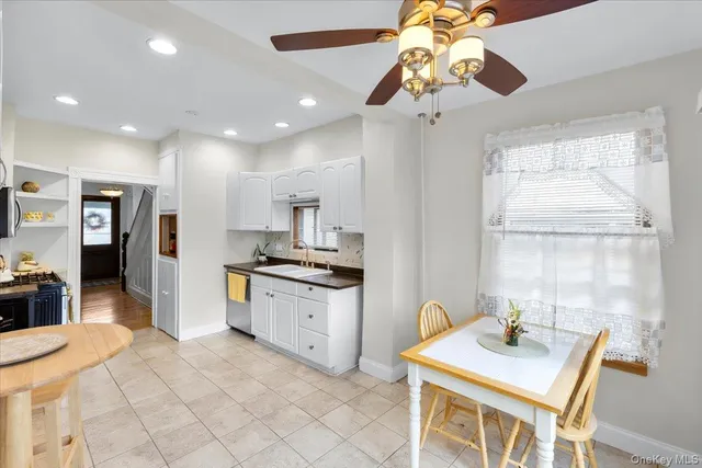 a white toilet sitting next to a bathroom sink
