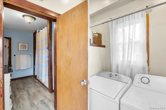 a living room with a large window and furniture