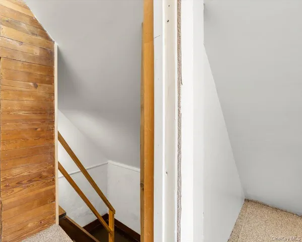 a view of room with cabinet and front door