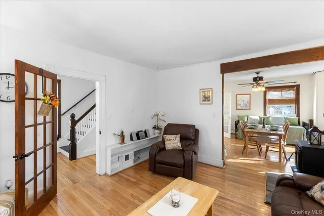 a living room with furniture rug and wooden floor