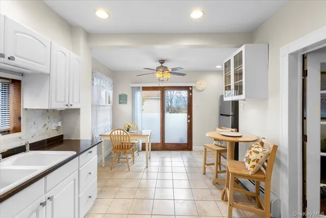 a kitchen with stainless steel appliances kitchen island granite countertop a refrigerator and microwave