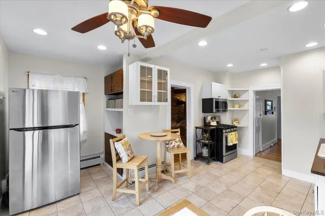 a view of kitchen with furniture and refrigerator