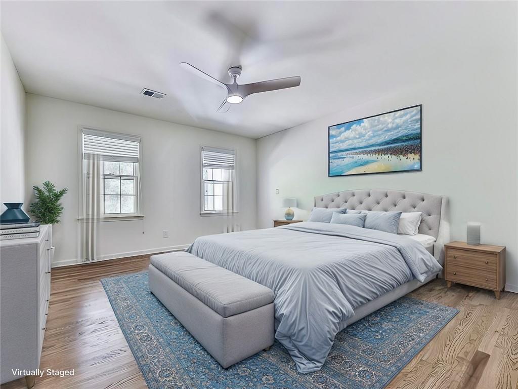 633 Butterworth Road Canton, GA 30114 - Photo 32 of 55 a spacious bedroom with a large bed couch and windows
