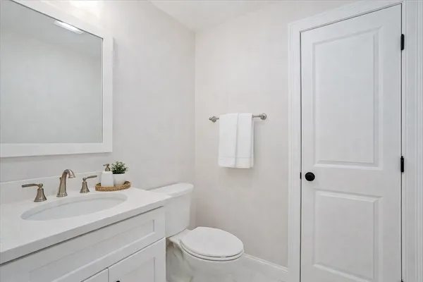 a bathroom with a sink toilet and vanity