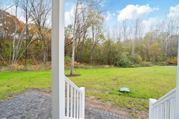 a view of a backyard with large trees