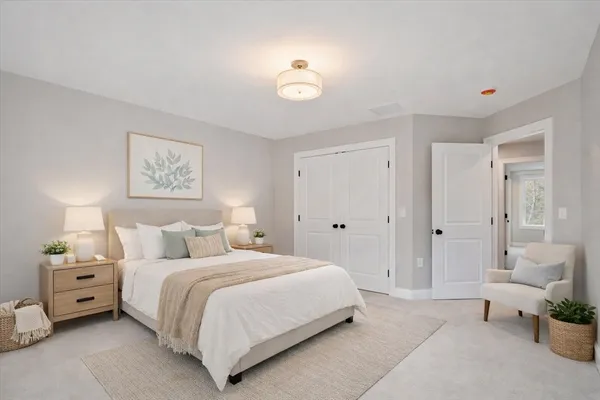 a bedroom with a bed and a lamp