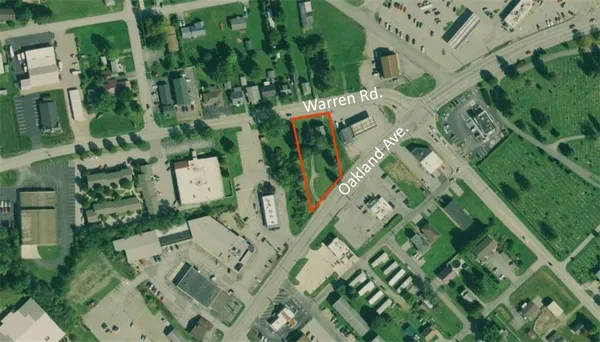 an aerial view of multi story residential apartment building with entryway