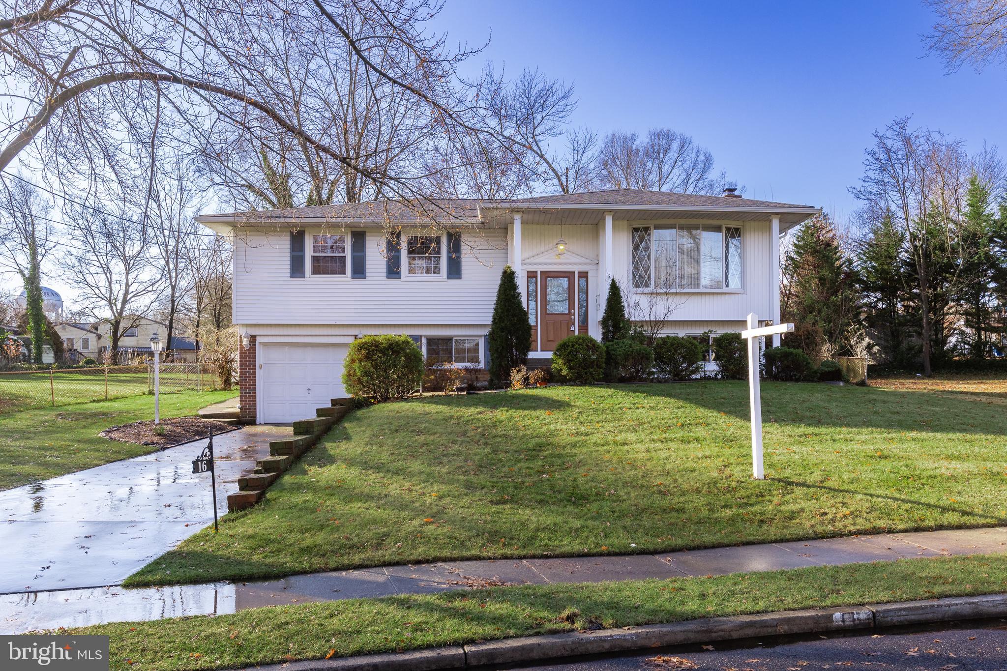 a view of a house with a yard and a garden