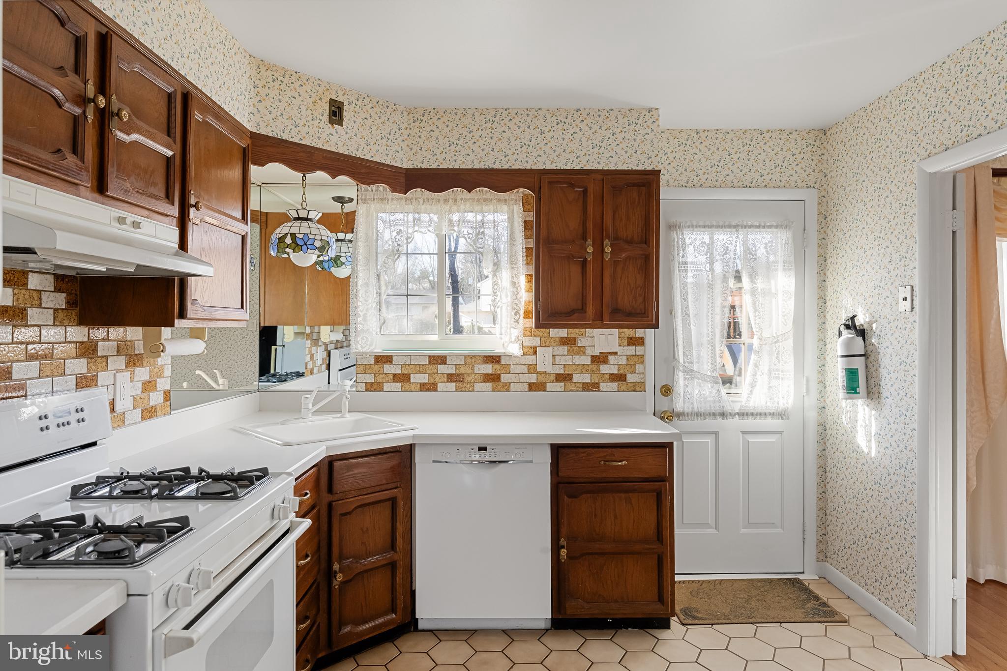 16 Hunter Drive Delran, NJ 08075 - Photo 11 of 29 a kitchen with stainless steel appliances granite countertop a stove and a refrigerator