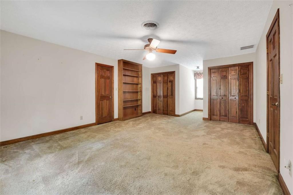 314 Winding Stream Trail Southwest Conyers, GA 30094 - Photo 44 of 59 an empty room with closet and a ceiling fan