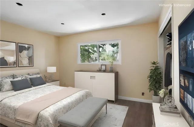 a view of a livingroom with wooden floor and a refrigerator