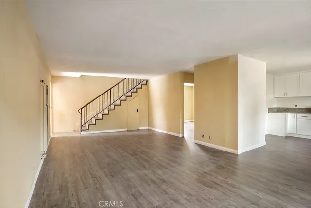 a kitchen with granite countertop white cabinets and stainless steel appliances