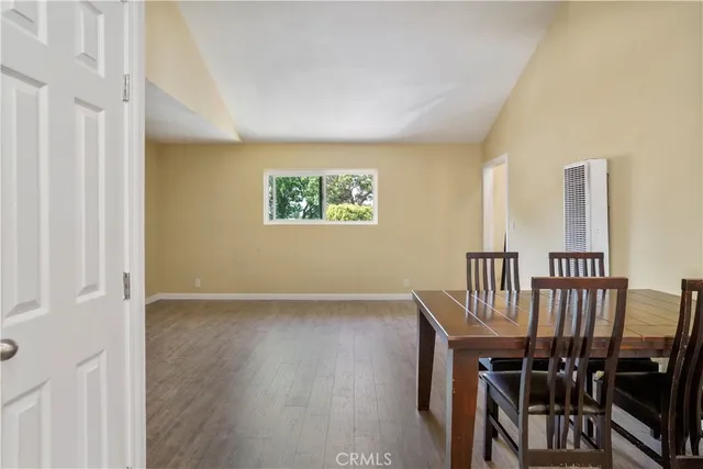 a view of a hallway with wooden floor and furniture