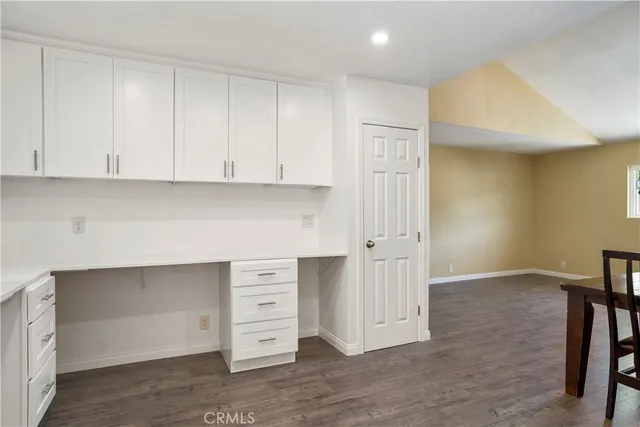 an empty room with wooden floor and window