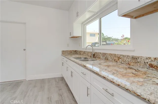 an aerial view of a house with swimming pool and large trees