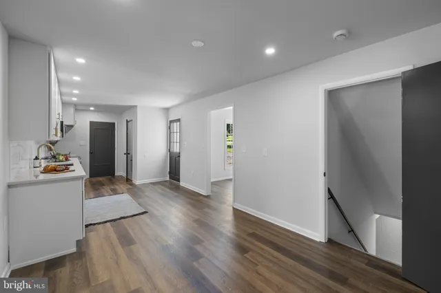 a view of a kitchen with wooden floor and a refrigerator