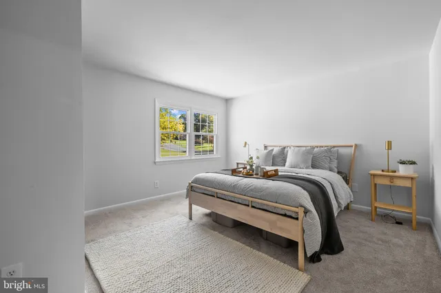 a spacious bedroom with a bed and a window