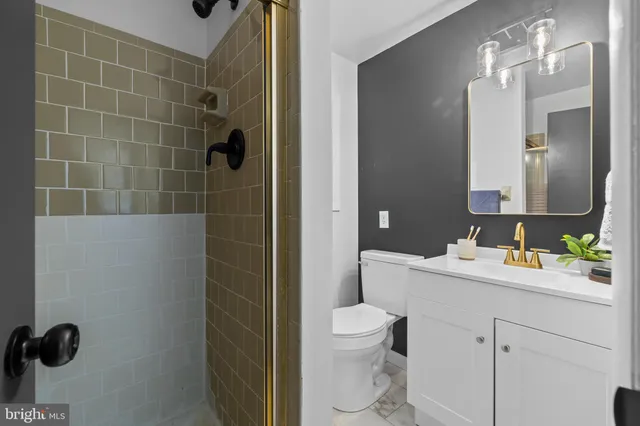 a bathroom with a toilet sink a shower and