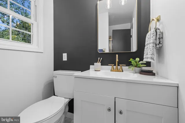 a bathroom with a toilet sink and mirror