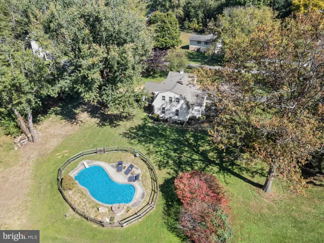an aerial view of a house with a swimming pool