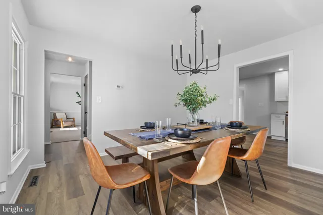 a view of a dining room with furniture wooden floor and chandelier