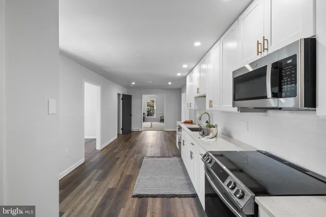 a view of living room kitchen with furniture and flat screen tv