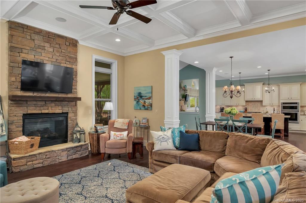 1401 Delaney Drive Weddington, NC 28104 - Photo 15 of 48 a living room with furniture a flat screen tv and a fireplace