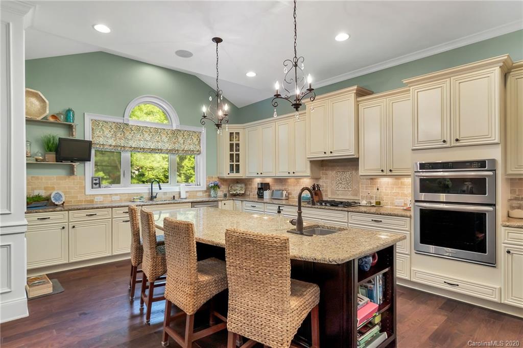 1401 Delaney Drive Weddington, NC 28104 - Photo 19 of 48 a kitchen with stainless steel appliances granite countertop a stove a sink a microwave a center island and a cabinets
