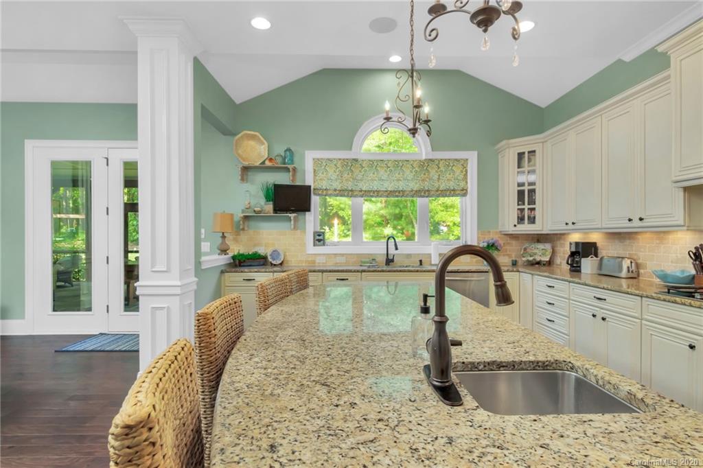 1401 Delaney Drive Weddington, NC 28104 - Photo 20 of 48 a kitchen with a sink a counter top space and living room view