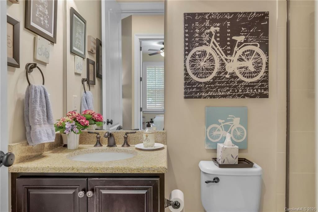 1401 Delaney Drive Weddington, NC 28104 - Photo 23 of 48 a bathroom with a granite countertop sink a toilet and a mirror