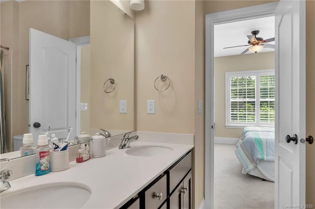 1401 Delaney Drive Weddington, NC 28104 - Photo 29 of 48 a en suite bathroom with a granite countertop sink and a mirror