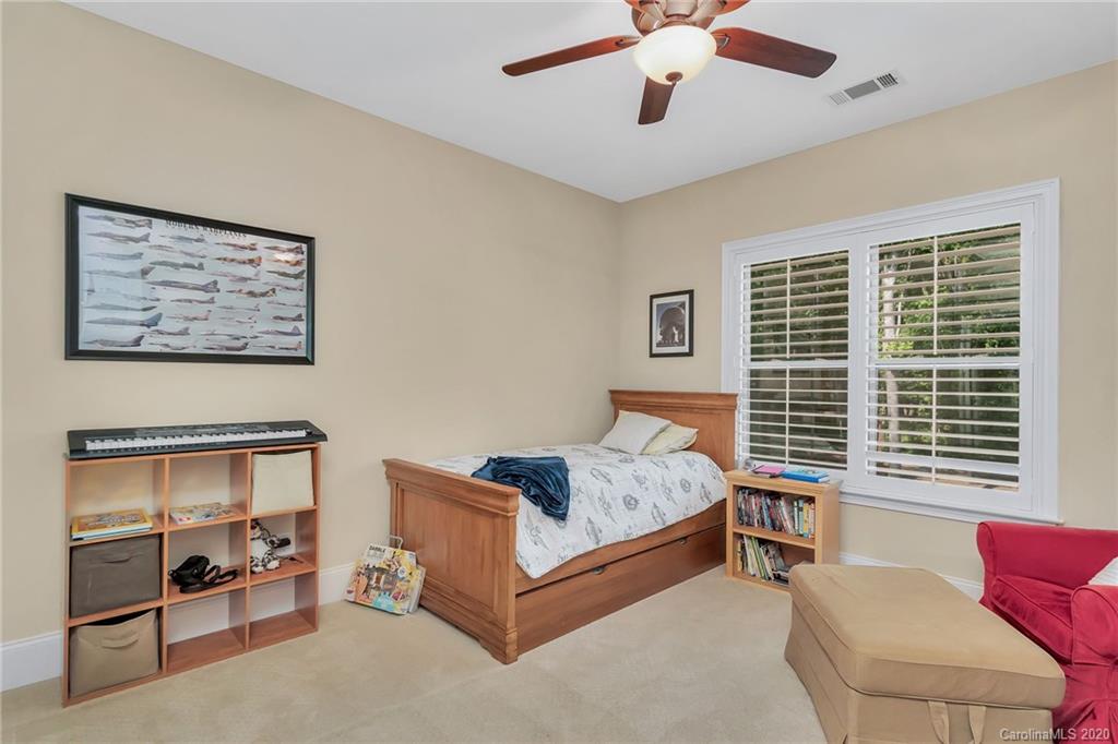 1401 Delaney Drive Weddington, NC 28104 - Photo 30 of 48 a bedroom with a bed and a couch