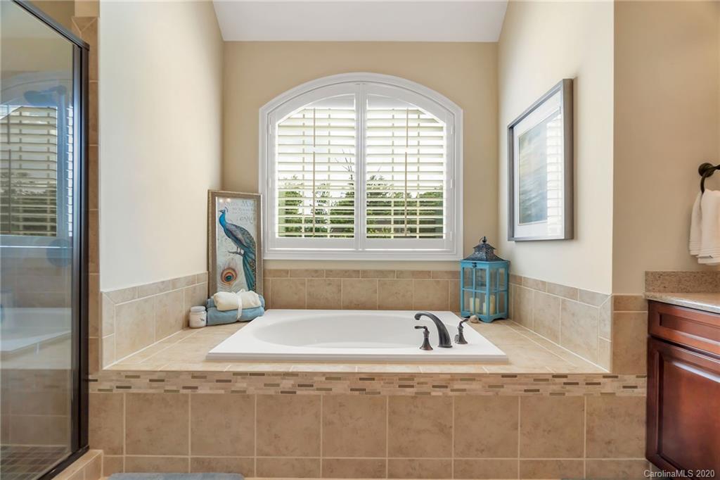 1401 Delaney Drive Weddington, NC 28104 - Photo 36 of 48 a bath tub sitting in a bathroom next to a window