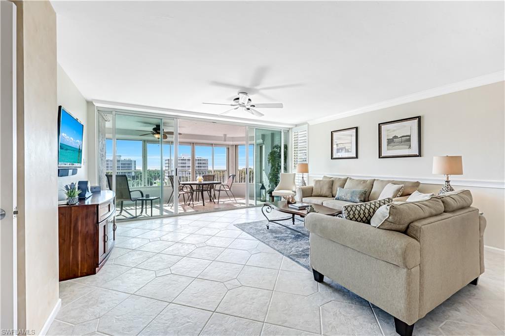 21 Bluebill Avenue, Unit B503 Naples, FL 34108 - Photo 12 of 40 a living room with furniture and a table