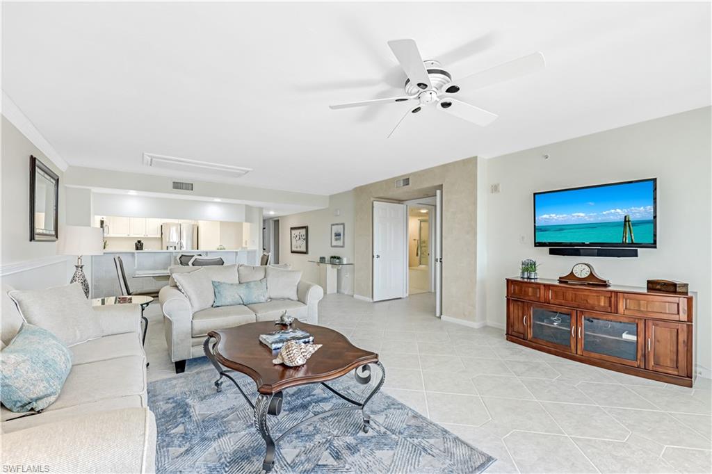21 Bluebill Avenue, Unit B503 Naples, FL 34108 - Photo 14 of 40 a living room with furniture and a flat screen tv