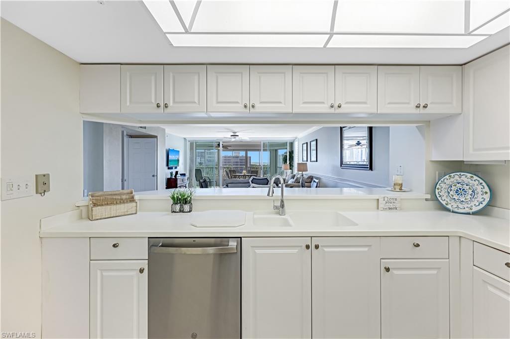 21 Bluebill Avenue, Unit B503 Naples, FL 34108 - Photo 16 of 40 a kitchen with stainless steel appliances granite countertop a sink and cabinets