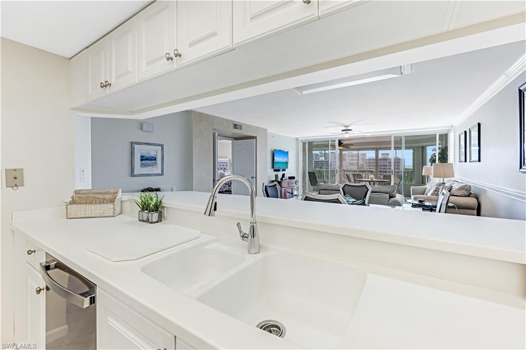 21 Bluebill Avenue, Unit B503 Naples, FL 34108 - Photo 17 of 40 a bathroom with a sink and a mirror