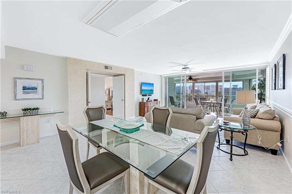 21 Bluebill Avenue, Unit B503 Naples, FL 34108 - Photo 19 of 40 a living room with furniture and a table
