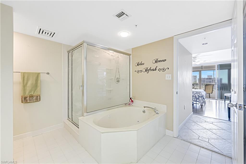 21 Bluebill Avenue, Unit B503 Naples, FL 34108 - Photo 24 of 40 a bathroom with a bathtub and a shower
