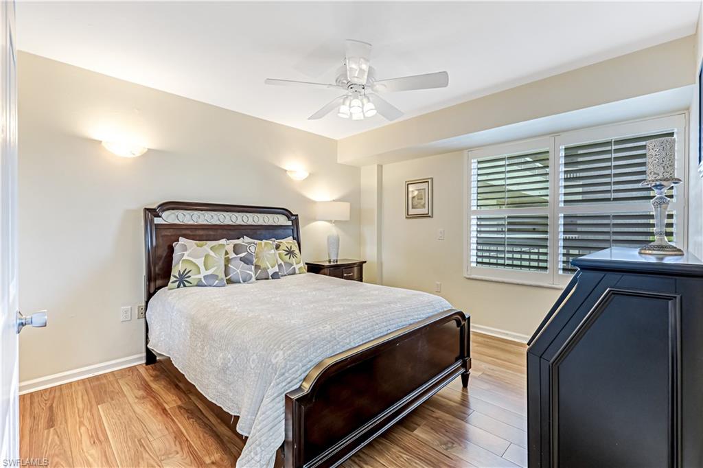21 Bluebill Avenue, Unit B503 Naples, FL 34108 - Photo 27 of 40 a bedroom with a bed and window
