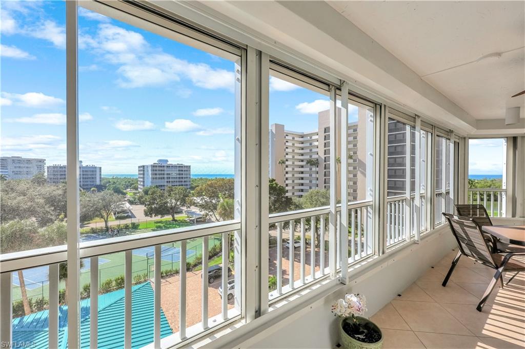 21 Bluebill Avenue, Unit B503 Naples, FL 34108 - Photo 30 of 40 a view of a city from a balcony with furniture