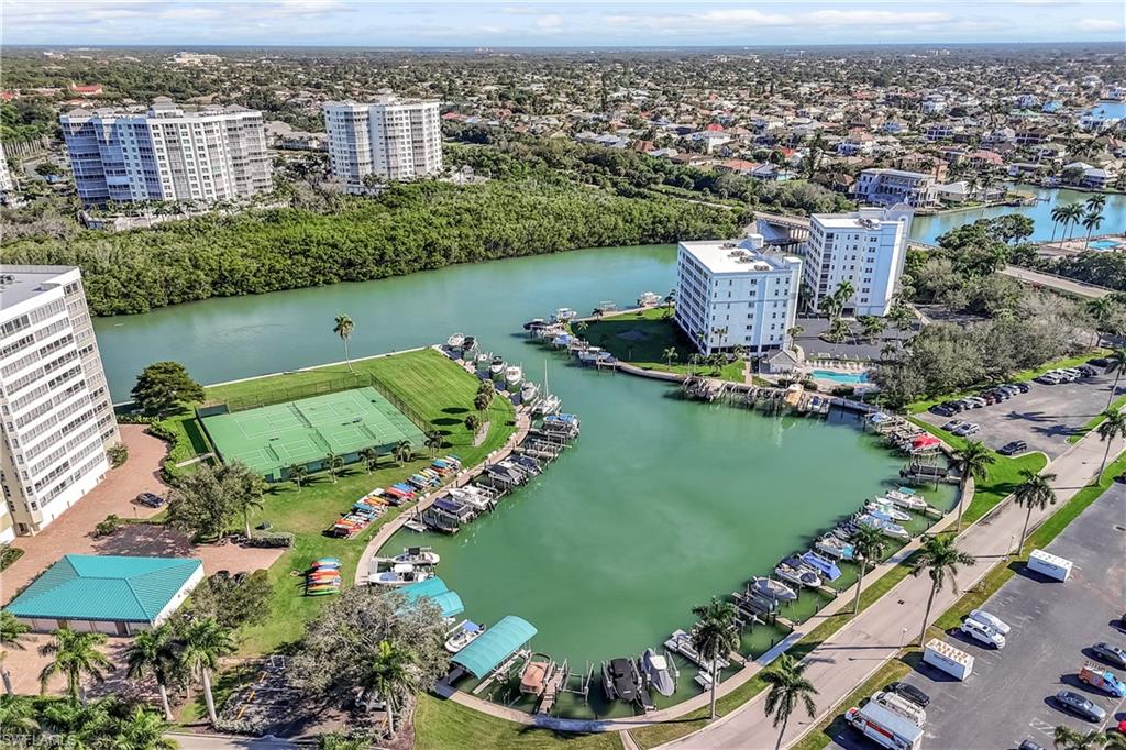 21 Bluebill Avenue, Unit B503 Naples, FL 34108 - Photo 34 of 40 an aerial view of a house with a garden and lake view