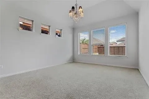 a view of a livingroom with wooden floor and a kitchen space