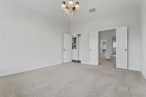 a view of an empty room with wooden floor fireplace and a window