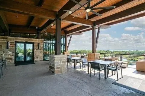 a view of a house with floor to ceiling windows and a yard