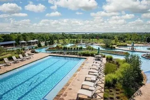 a view of a yard with swimming pool and wooden fence