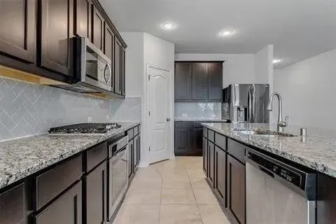 a kitchen with sink and chandelier